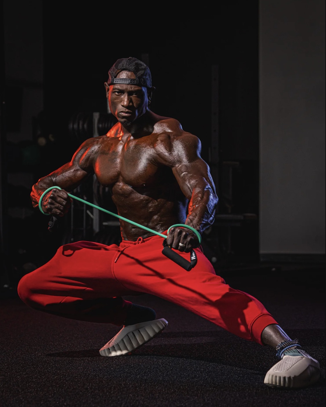 Coach JR in a low lunge pulling a resistance band
