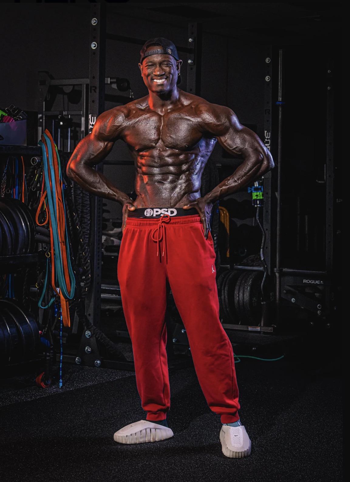 Coach JR smiling in his gym, hands on hips